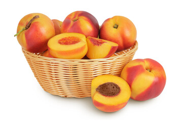 Ripe nectarine fruit with half in a wicker basket isolated on white background with full depth of field