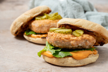 Salmon fishburger english muffin sandwich