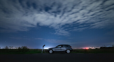 Fototapeta na wymiar Telescope with car at night 