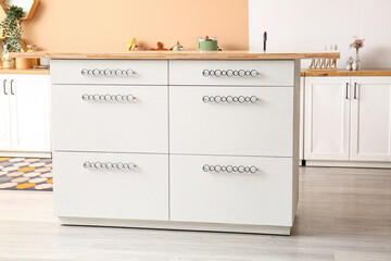 Table with drawers in interior of stylish kitchen