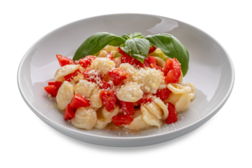 Pasta orecchiette seasoned with fresh tomato, olive oil and with basil leaves and parmisan  in white plate isolated. Typical Italian Apulian recipe