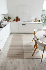 Stylish beige carpet in interior of modern kitchen