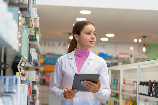 Female pharmacist with a digital tablet in the pharmacy