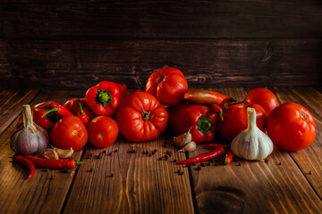 Red tomatoes and peppers on wooden table
