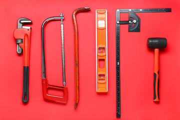 Set of construction tools on red background