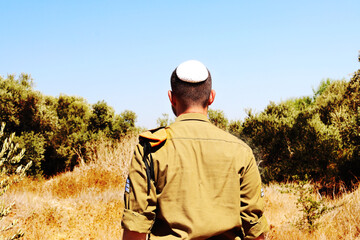 Religious Jewish soldier of the Israel Defense Forces - IDF - Tzahal . Israeli soldier with a kippah on his head with the rank of sergeant - obrazy, fototapety, plakaty