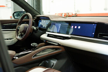 interior of a new super modern electric SUV with three multimedia displays on the panel