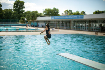 children and teenagers exercising on the trampoline at a water park