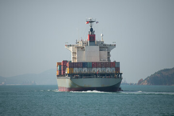 Logistics and transportation of Container Cargo ship and Refrigerated container being loaded on a container ship