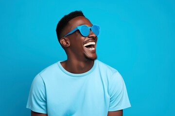 black man with sunglasses and comical face on blue background - obrazy, fototapety, plakaty