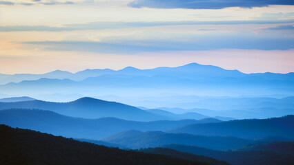 Mountains in silhouette with shadows of blue hues