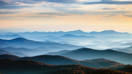 Obraz premium Mountains in silhouette with shadows of blue hues