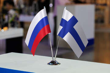 Flags of Russia and Finland together at some event or fair. Flags of the two countries as a symbol of cooperation between states. Joint business of Finland and the Russian Federation