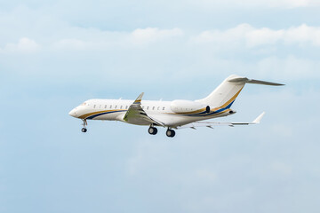 A private white small business jet comes in for a landing. Jet corporate business aviation....