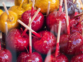 Delicious and Sweet Red and Yellow Candied Apples on Stick