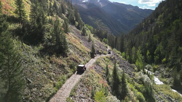 Aerial of jeeps four wheeling on high mountain pass in Crested Butte Colorado in Elk Mountain Range