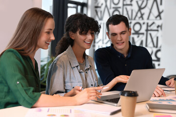 Team of employees working together at table in office. Startup project