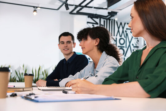 Team of employees working together at table in office. Startup project