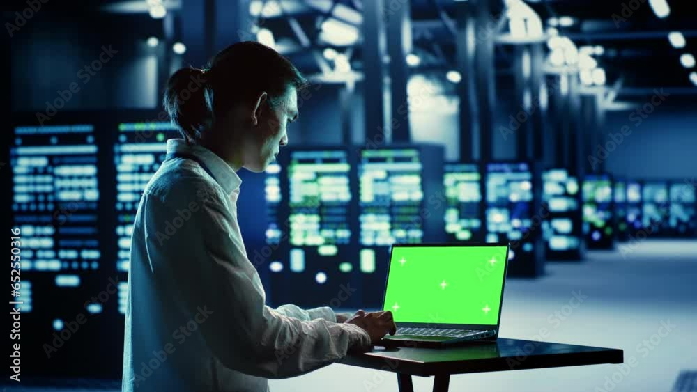 Poster it consultant running code on chroma key laptop, troubleshooting data center equipment. cloud comput
