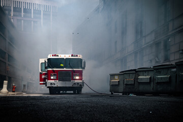 Firetruck responding to smokey alleyway