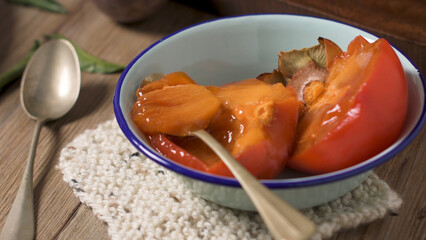 Persimmon fruit on rustic table
