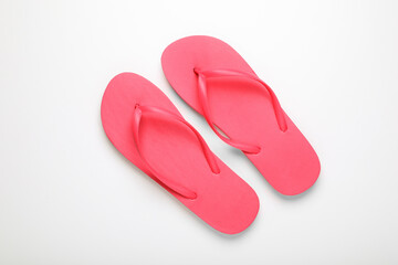 Stylish pink flip flops on white background, top view