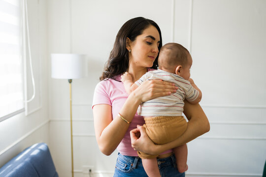Loving mother with her baby burping gas