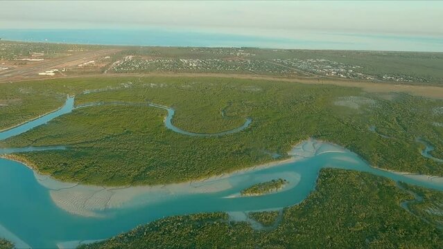 Flying over Dampier Peninsula after taking off from Broome airport with aerial view of mangroves and rivers