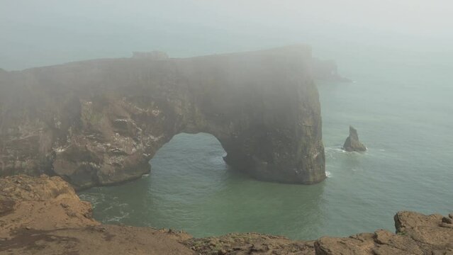 Dyrholaey headland sea arch Iceland covered in fog