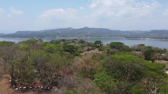 Flyover hilly landscape toward Cerron Grande Reservoir, El Salvador