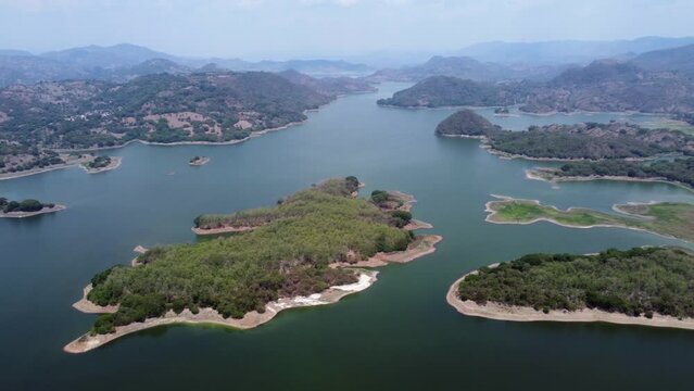 Rotating aerial over sprawling low water Cerron Grande Reservoir, SLV