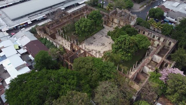 Aerial orbits roofless historic building ruin in Santa Ana El Salvador