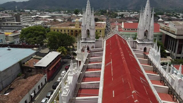 Flyover red metal roof to tall gothic spires of Santa Ana Cathedral