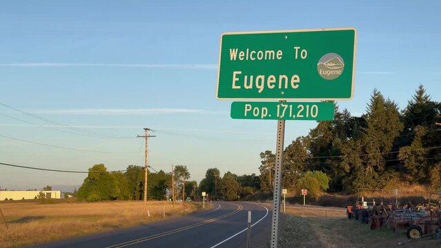 Roadside signage of Eugene, Oregon, welcoming and listing the population.
