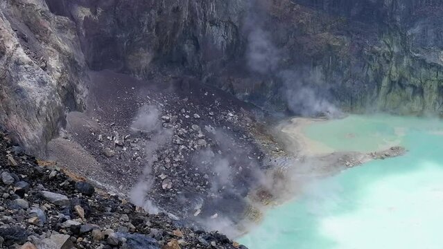 Steam rises off opaque green lake in crater of Santa Ana Volcano, SLV