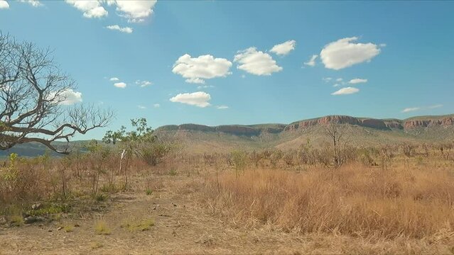 Driving south to north along Western Australian outback highway through desert and red earth