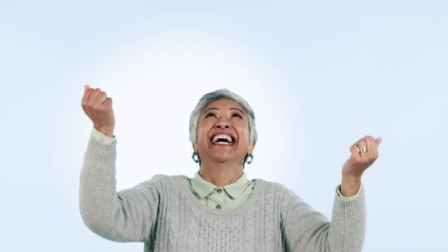 Woman, hands and catch in studio with excited face for money, winner prize or lottery on blue background. Senior, person and grab falling bonus with happiness for cash opportunity or achievement
