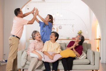 Group of Asian senior and caregiver having fun in the nursing home.