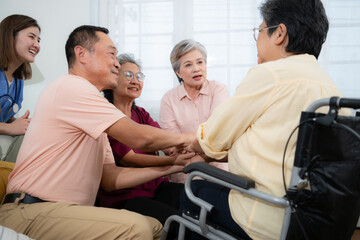 Group of asian senior and young female nurse holding hands together at living room of house