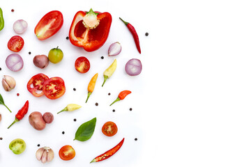 Various fresh vegetables and herbs on white background.
