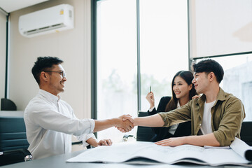 Engineers, designers and interior designers are handshake shack hands deal finalizing the design of interiors by discussing selecting materials and colors to design rooms to present to clients.