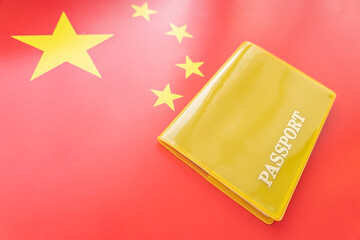 Flag of china with passport. Travel visa and citizenship concept. residence permit in the country. a yellow document with the inscription passport is on flag. Close up, top view