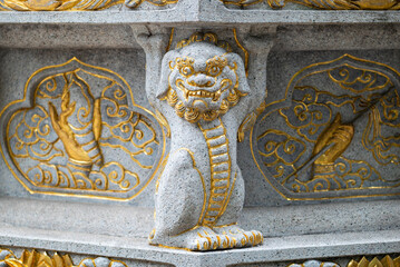 Stone dragon statue with golden colored ornaments in Daci buddhist temple, Chengdu, Sichuan province, China - 652594749