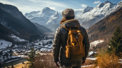 A young traveling men in winter wilderness in a panoramic mountain landscape