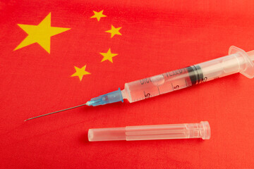 Vaccine, syringes and Chinese flag. Microbiological research in China. Development of antiviral...