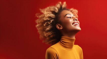 Happy young African American woman standing against red background.