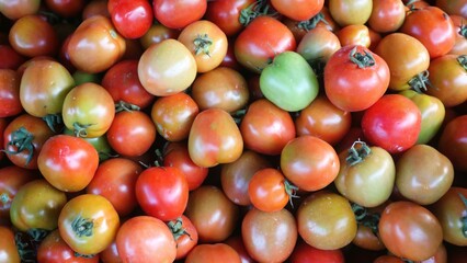 Top view pile of raw tomatoes, natural background