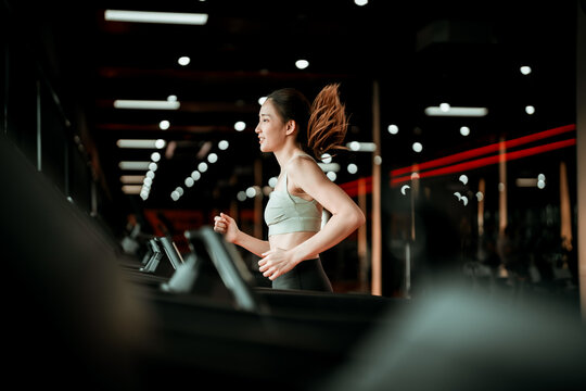 Young Asian Woman Running On Treadmill - Fitness Gym Exercise