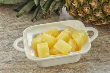 Marinated pineapple slices in the bowl