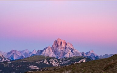 Rock against the colorful sunrise sky. Dolomites. Italy 